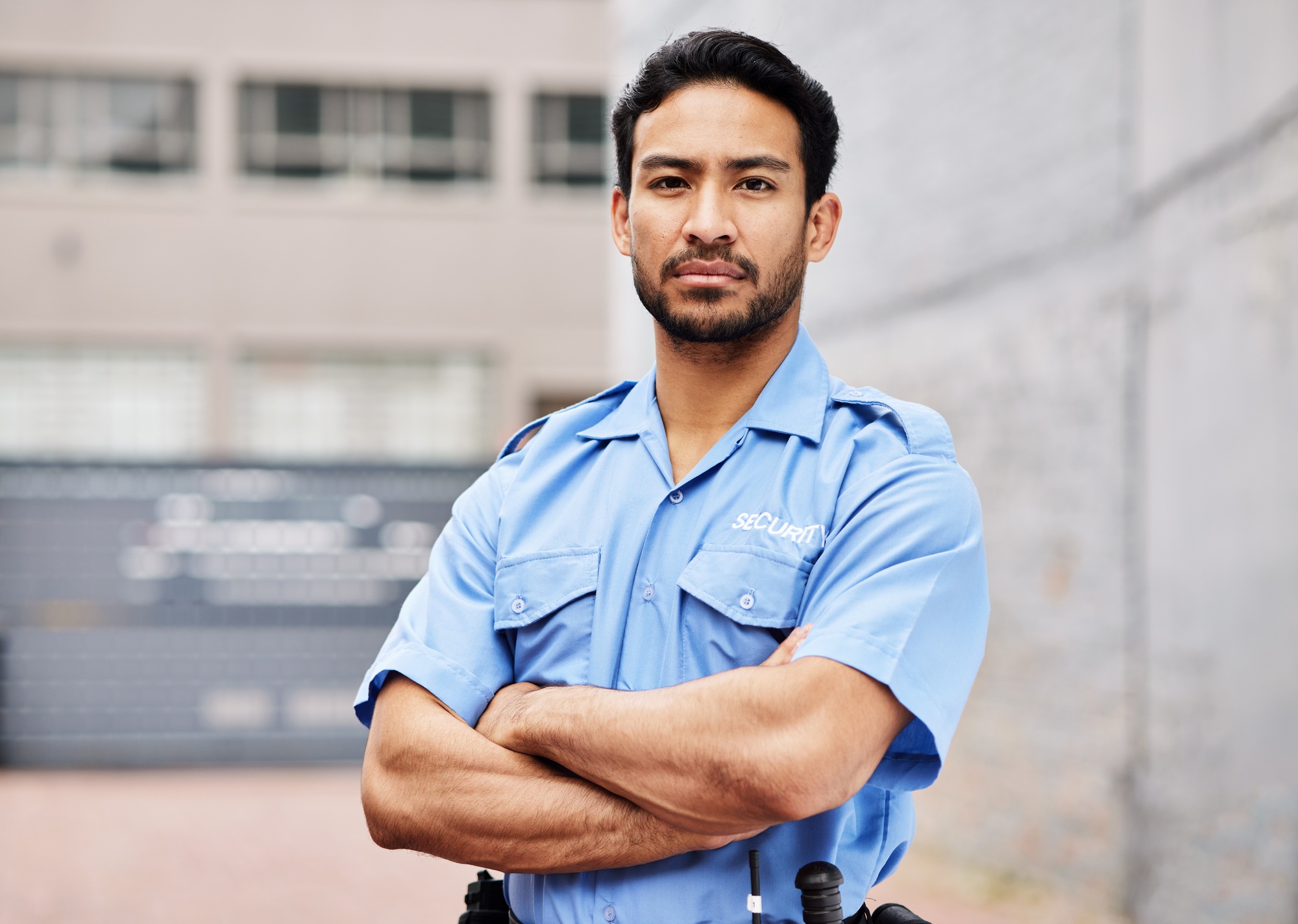 Portrait, man and security guard with arms crossed for police service, protection and safety in cit