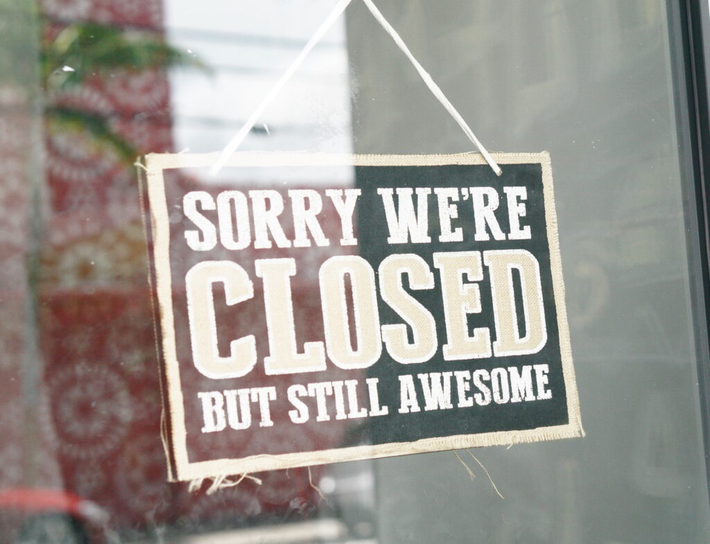 Small business with sorry we’re closed sign